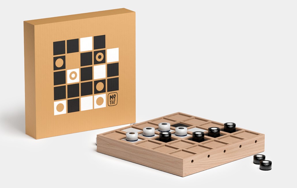 The Motif box next to the wooden Motif board with black and white tokens